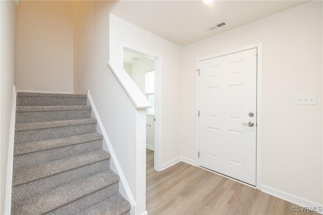 1712 Binford Ct, Cobbs Creek, VA 23223 - foyer featuring light wood-style floors and stairs