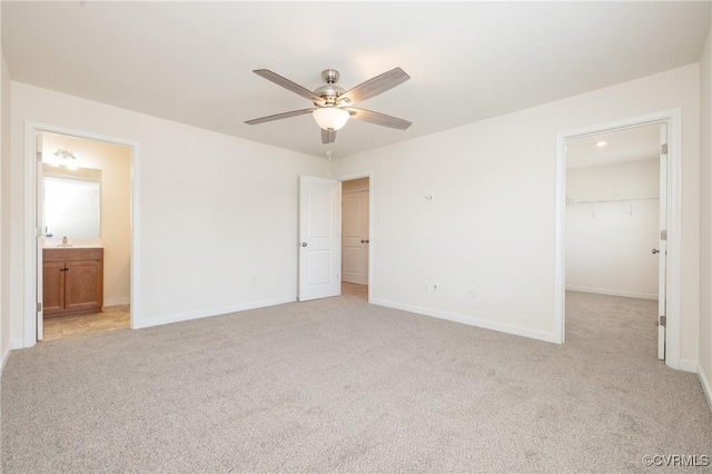 1712 Binford Ct, Cobbs Creek, VA 23223 - unfurnished bedroom featuring light carpet, a spacious closet, a closet, ensuite bathroom, and a ceiling fan