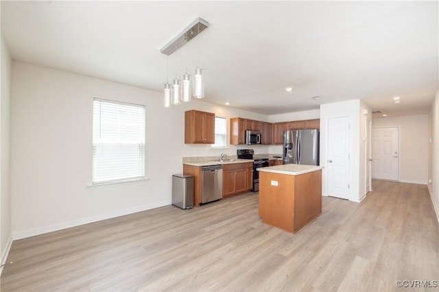 1712 Binford Ct, Cobbs Creek, VA 23223 - kitchen featuring appliances with stainless steel finishes, light countertops, light wood-style floors, brown cabinetry, and plenty of natural light