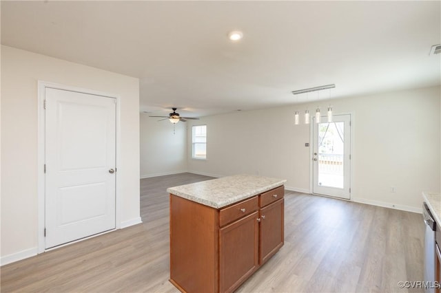1712 Binford Ct, Cobbs Creek, VA 23223 - kitchen with light wood-style flooring, brown cabinets, a ceiling fan, light countertops, and hanging light fixtures
