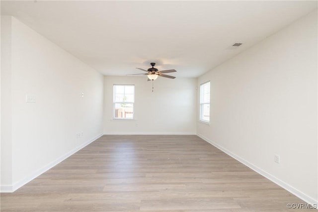 1712 Binford Ct, Cobbs Creek, VA 23223 - empty room featuring plenty of natural light, ceiling fan, and light wood-style floors
