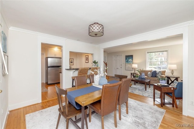 4024 W Grace St, Richmond, VA 23230 - dining space featuring light wood-style floors and crown molding