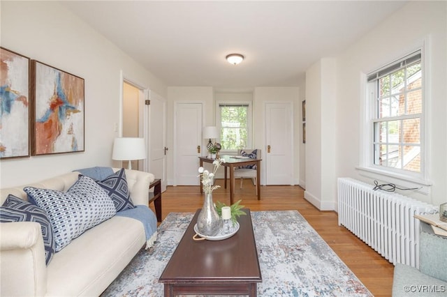 4024 W Grace St, Richmond, VA 23230 - living area with radiator, healthy amount of natural light, and wood finished floors