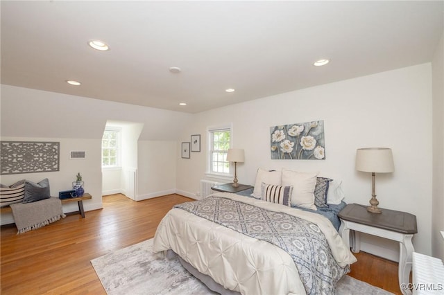 4024 W Grace St, Richmond, VA 23230 - bedroom with multiple windows, wood finished floors, recessed lighting, vaulted ceiling, and radiator