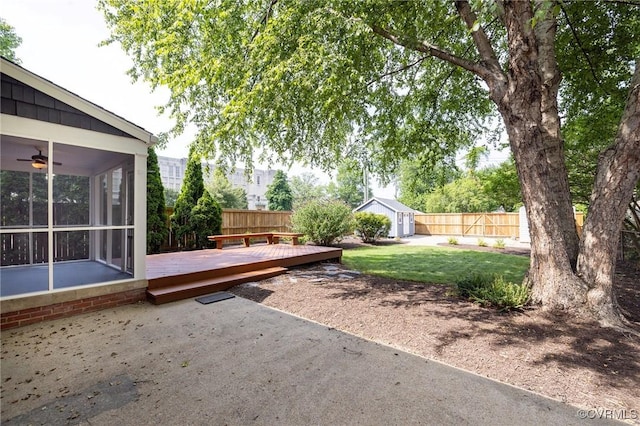 4024 W Grace St, Richmond, VA 23230 - fenced backyard featuring a deck, a patio area, a sunroom, a ceiling fan, and a shed