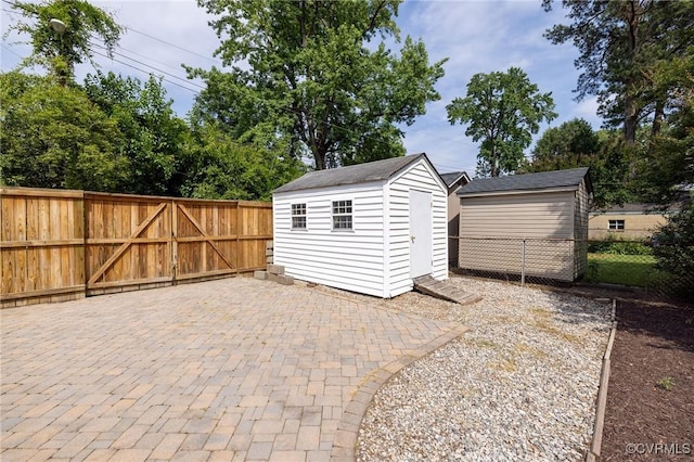 4024 W Grace St, Richmond, VA 23230 - fenced backyard featuring a patio and a storage unit