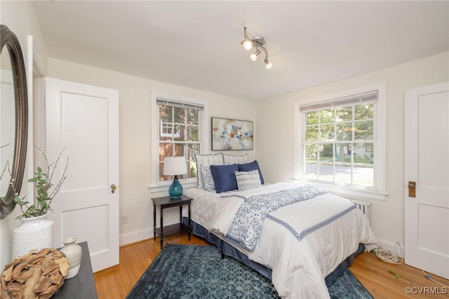 4024 W Grace St, Richmond, VA 23230 - bedroom featuring wood finished floors and radiator