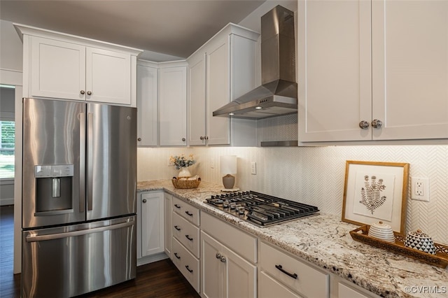9377 Magnolia Blossom Rd, Ashland, VA 23005 - kitchen featuring appliances with stainless steel finishes, wall chimney exhaust hood, decorative backsplash, light stone counters, and white cabinetry