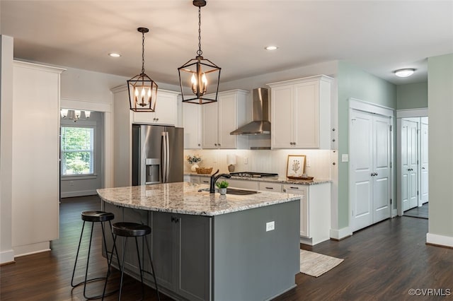 9377 Magnolia Blossom Rd, Ashland, VA 23005 - kitchen featuring stainless steel appliances, wall chimney range hood, dark wood-style flooring, a chandelier, and white cabinets