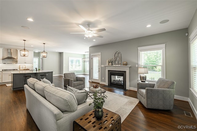 9377 Magnolia Blossom Rd, Ashland, VA 23005 - living room featuring recessed lighting, dark wood-type flooring, a multi sided fireplace, and ceiling fan