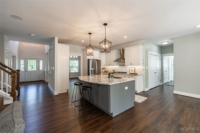 9377 Magnolia Blossom Rd, Ashland, VA 23005 - kitchen with wall chimney exhaust hood, stainless steel appliances, dark wood-style floors, light stone countertops, and recessed lighting