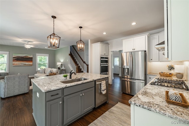 9377 Magnolia Blossom Rd, Ashland, VA 23005 - kitchen with stainless steel appliances, open floor plan, white cabinetry, an island with sink, and custom range hood