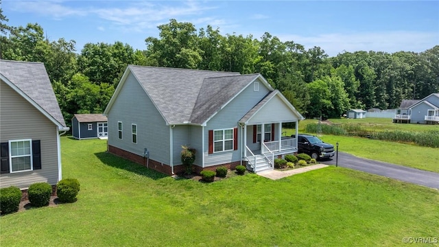 9949 Reymet Ct, North Chesterfield, VA 23237 - view of front of house with covered porch, a front yard, asphalt driveway, and a shingled roof