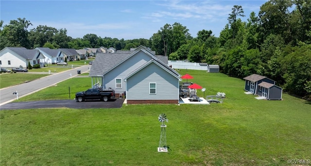 9949 Reymet Ct, North Chesterfield, VA 23237 - view of home's exterior with a storage shed, a lawn, and driveway