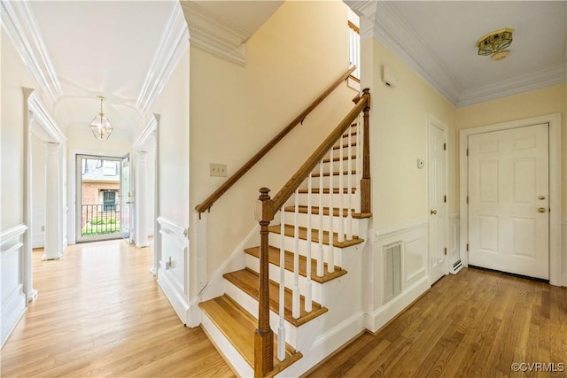 13905 Durhamshire Ln, Midlothian, VA 23113 - stairs featuring crown molding, wood finished floors, a chandelier, and a decorative wall