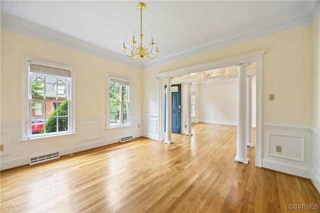 13905 Durhamshire Ln, Midlothian, VA 23113 - spare room with a chandelier, light wood-style floors, decorative columns, ornamental molding, and wainscoting