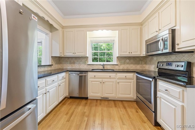13905 Durhamshire Ln, Midlothian, VA 23113 - kitchen featuring appliances with stainless steel finishes, ornamental molding, light wood finished floors, and backsplash