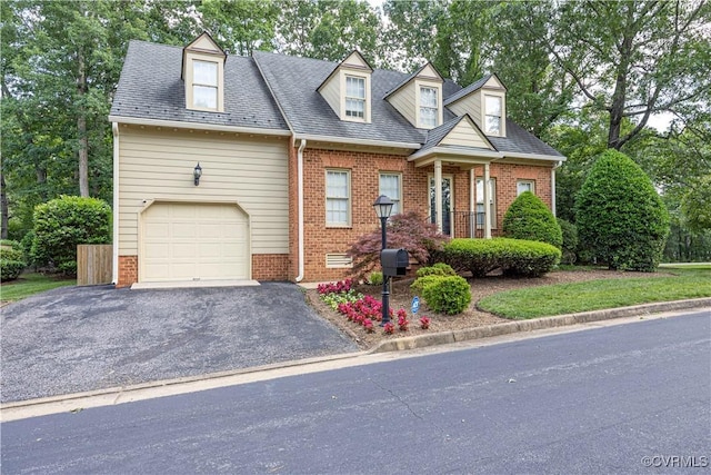 13905 Durhamshire Ln, Midlothian, VA 23113 - cape cod home featuring brick siding, asphalt driveway, and view of wooded area