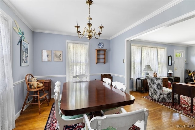 1708 Hollandale Rd, Henrico, VA 23238 - dining space featuring a chandelier, healthy amount of natural light, wood finished floors, and ornamental molding
