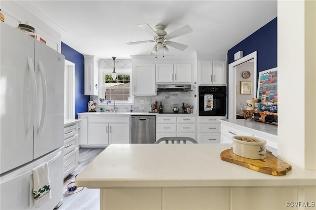 1708 Hollandale Rd, Henrico, VA 23238 - kitchen with freestanding refrigerator, oven, stainless steel dishwasher, under cabinet range hood, and a ceiling fan