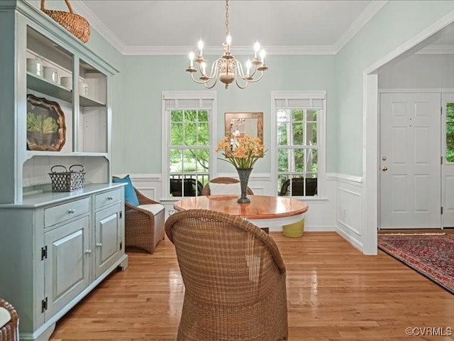 4416 Killiam Ct, Henrico, VA 23060 - dining space featuring a chandelier, healthy amount of natural light, light wood-style flooring, ornamental molding, and wainscoting