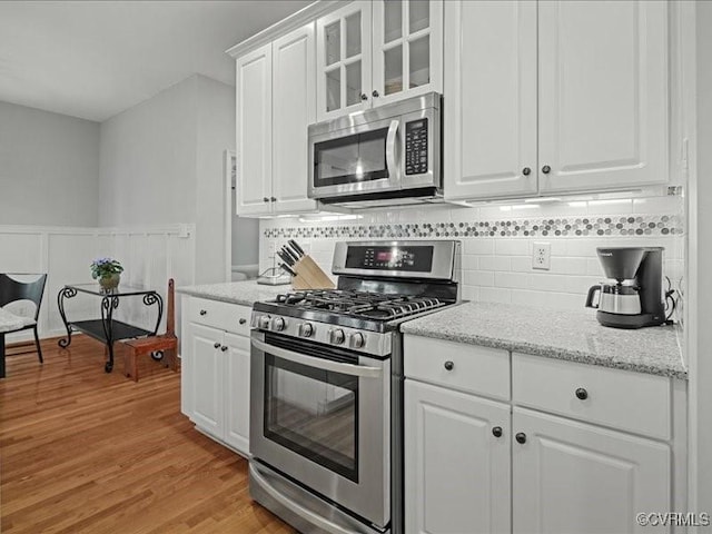 4416 Killiam Ct, Henrico, VA 23060 - kitchen featuring stainless steel appliances, light wood-style floors, white cabinets, decorative backsplash, and glass insert cabinets