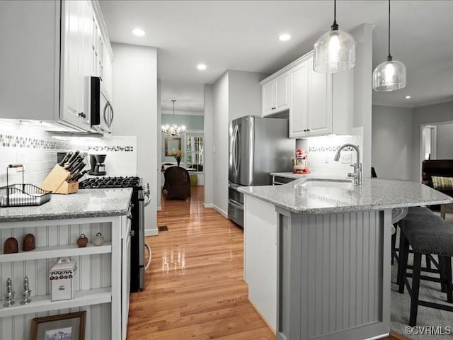 4416 Killiam Ct, Henrico, VA 23060 - kitchen with stainless steel appliances, light wood-type flooring, tasteful backsplash, white cabinets, and recessed lighting