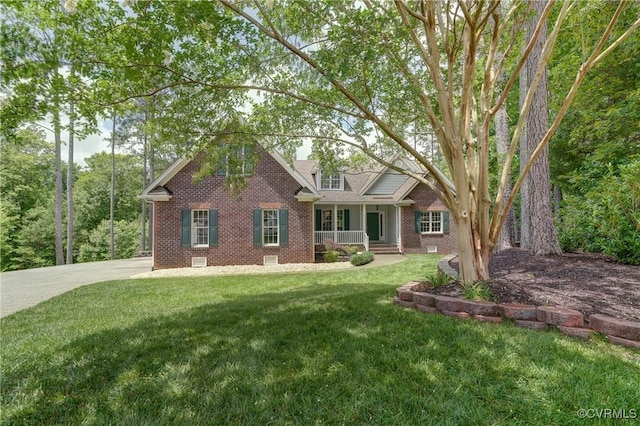 5501 Pine Needles Ter, Providence Forge, VA 23140 - view of front of home with brick siding, a front lawn, and covered porch