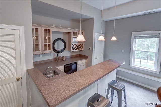 5501 Pine Needles Ter, Providence Forge, VA 23140 - kitchen with black dishwasher, a breakfast bar area, glass insert cabinets, decorative light fixtures, and a peninsula