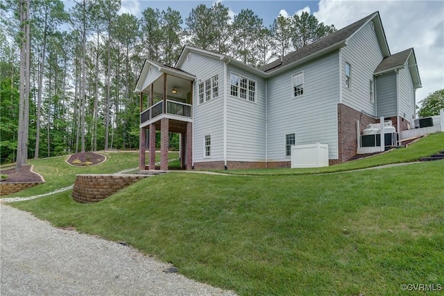 5501 Pine Needles Ter, Providence Forge, VA 23140 - rear view of property with a ceiling fan, a balcony, a yard, and brick siding