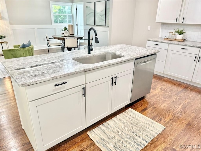 7335 Cherokee Rd, Richmond, VA 23225 - kitchen featuring dishwasher, a center island with sink, white cabinets, decorative backsplash, and light stone counters