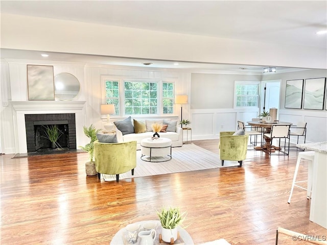 7335 Cherokee Rd, Richmond, VA 23225 - living area featuring a decorative wall, wood finished floors, a wainscoted wall, and a fireplace
