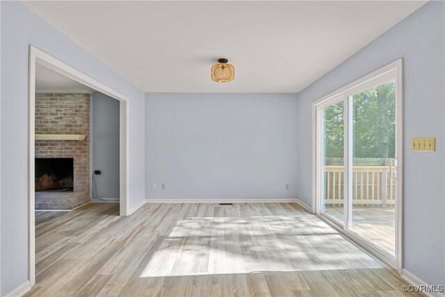 72 Whispering Pine Ln, Bumpass, VA 23024 - empty room featuring wood finished floors and a fireplace