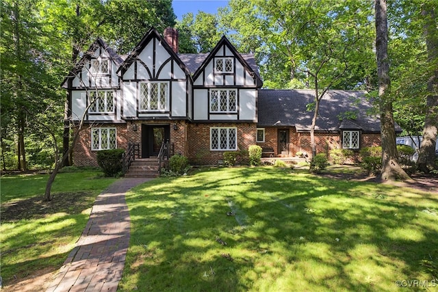 8327 Fulham Ct, Richmond, VA 23227 - english style home with a front lawn, brick siding, and a chimney
