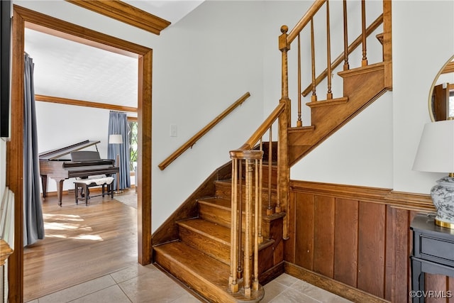 8327 Fulham Ct, Richmond, VA 23227 - stairway with a wainscoted wall and tile patterned floors