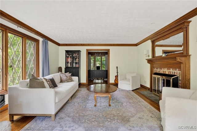 8327 Fulham Ct, Richmond, VA 23227 - living area featuring wood finished floors, a brick fireplace, and ornamental molding