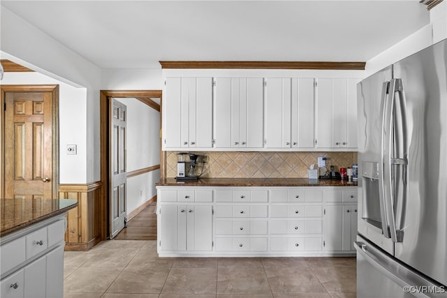 8327 Fulham Ct, Richmond, VA 23227 - kitchen featuring stainless steel refrigerator with ice dispenser, white cabinetry, decorative backsplash, dark stone countertops, and wainscoting