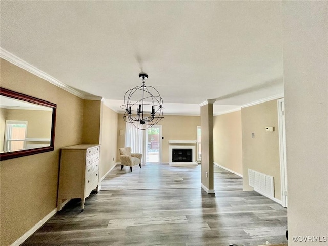 11767 N Briar Patch Dr, Midlothian, VA 23113 - unfurnished living room featuring crown molding, a chandelier, wood finished floors, and a fireplace with raised hearth