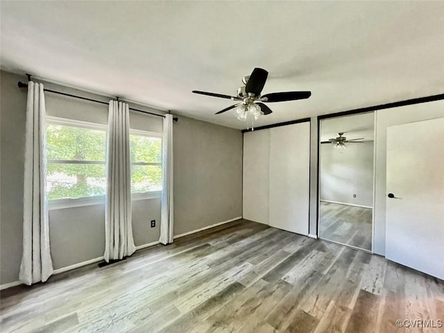 11767 N Briar Patch Dr, Midlothian, VA 23113 - unfurnished bedroom featuring two closets, wood finished floors, and a ceiling fan