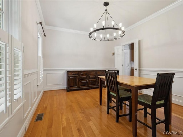 1960 Teal Ln, Powhatan, VA 23139 - dining space featuring a chandelier, ornamental molding, a wainscoted wall, light wood finished floors, and a decorative wall