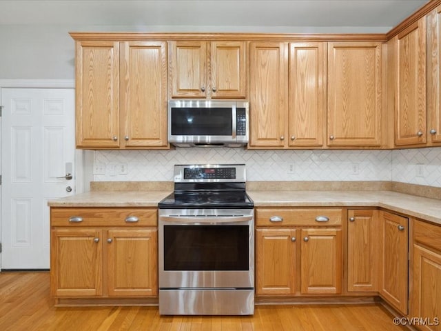 1960 Teal Ln, Powhatan, VA 23139 - kitchen featuring stainless steel appliances, light countertops, and tasteful backsplash