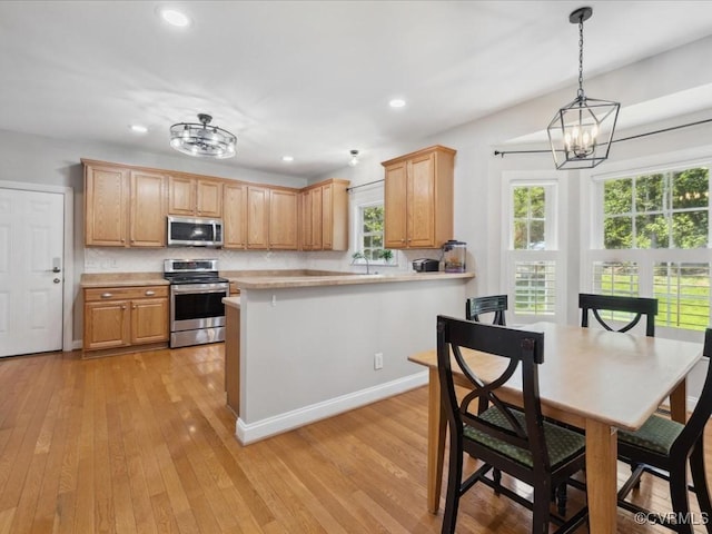 1960 Teal Ln, Powhatan, VA 23139 - kitchen with stainless steel appliances, light countertops, a chandelier, recessed lighting, and light wood finished floors