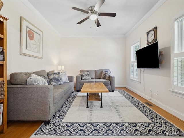 1960 Teal Ln, Powhatan, VA 23139 - living area featuring healthy amount of natural light, wood finished floors, ceiling fan, and ornamental molding