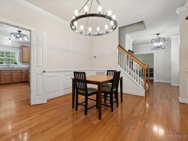 1960 Teal Ln, Powhatan, VA 23139 - dining area with a chandelier, stairway, crown molding, and light wood-style flooring