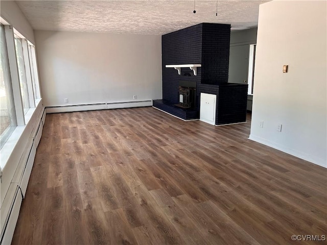 11532 Elmwood Ln, Chester, VA 23831 - unfurnished living room with a textured ceiling, baseboard heating, a fireplace, and dark wood-style flooring