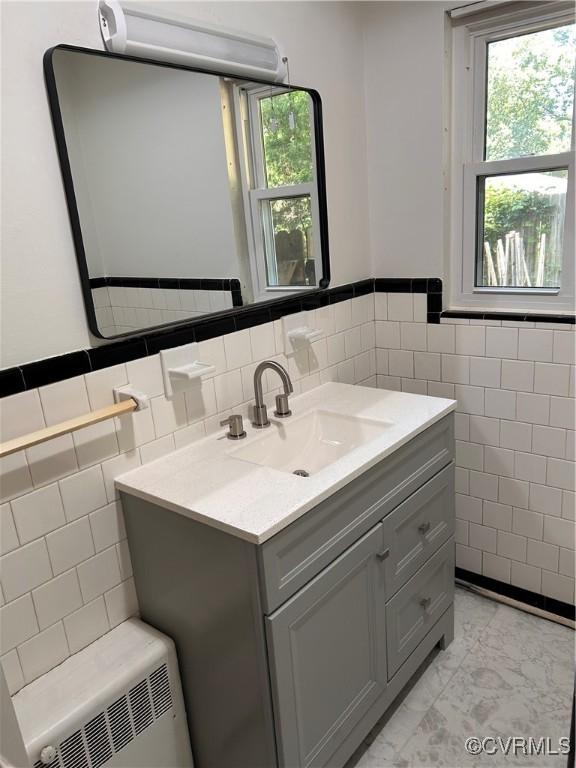 11532 Elmwood Ln, Chester, VA 23831 - bathroom with tile walls, vanity, healthy amount of natural light, a wainscoted wall, and marble finish floors