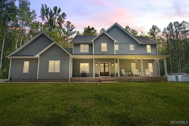 4788 Powhatan Lakes Rd, Powhatan, VA 23139 - view of front of property with a lawn, board and batten siding, a porch, and a storage shed