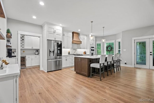 4788 Powhatan Lakes Rd, Powhatan, VA 23139 - kitchen featuring stainless steel appliances, light wood-type flooring, wine cooler, light countertops, and white cabinetry
