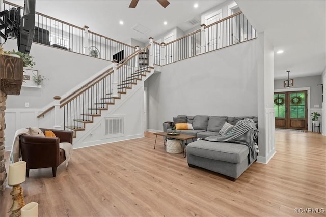 4788 Powhatan Lakes Rd, Powhatan, VA 23139 - living room featuring wood finished floors, stairs, a ceiling fan, a towering ceiling, and recessed lighting