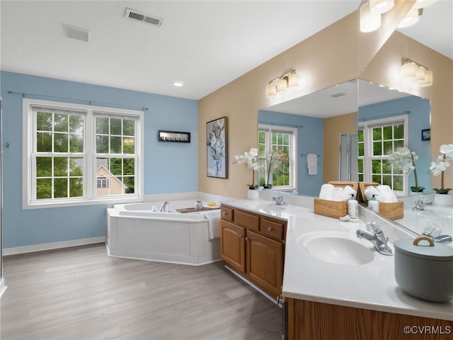 12306 Hollow Oak Ter, Midlothian, VA 23112 - full bath with double vanity, wood finished floors, and a garden tub